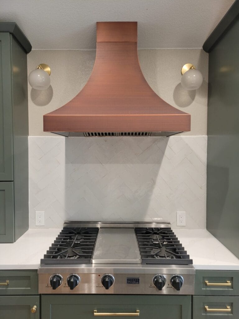 Kitchen remodel with new cabinets, countertops, backsplash, upgraded stove hood, and enhanced lighting for a complete transformation