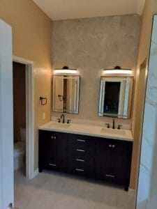 Double sink vanity with modern fixtures and lighting.