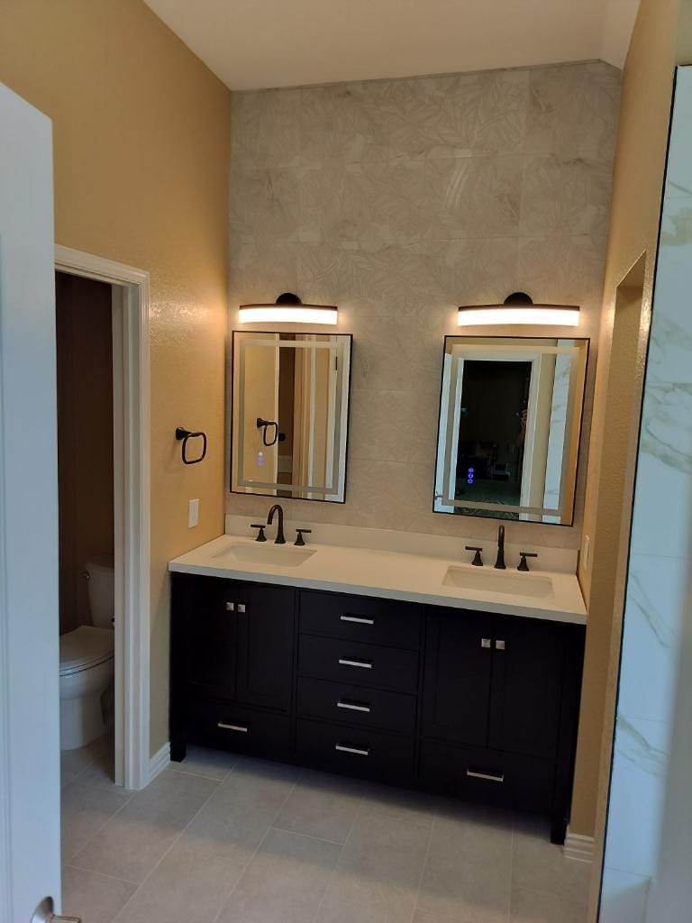 Double sink vanity with modern fixtures and lighting.