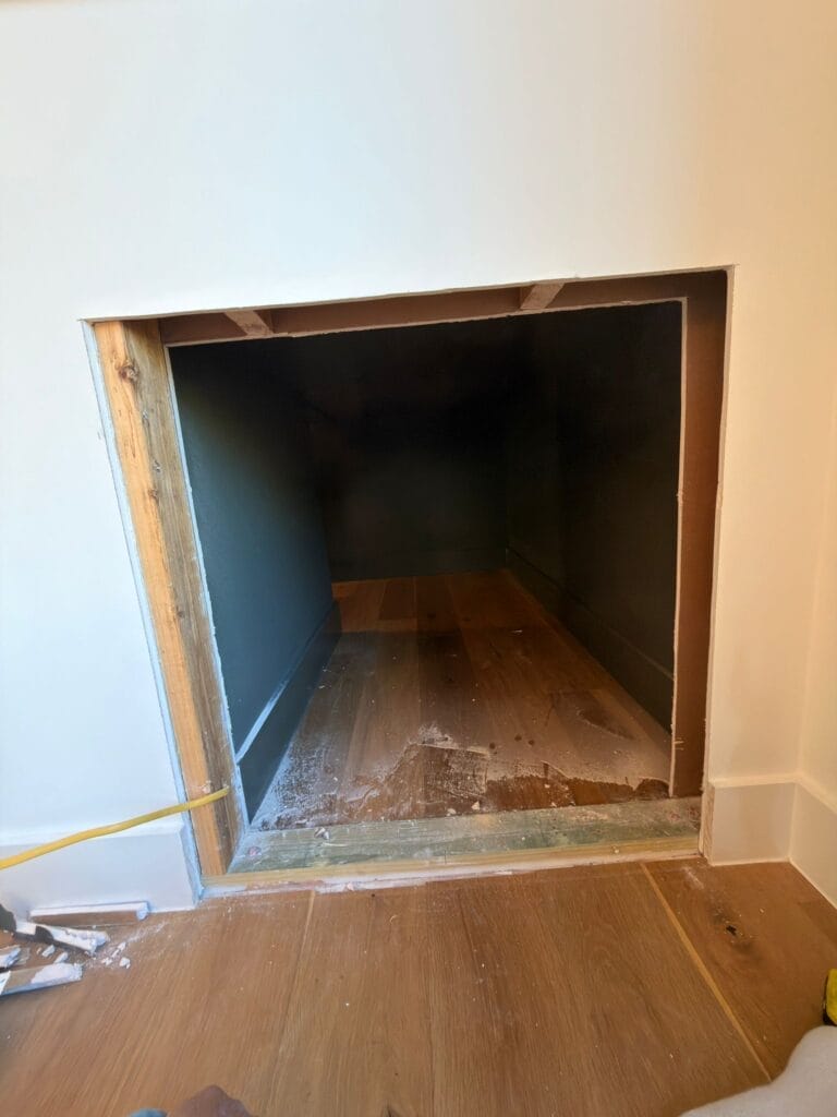 Exposed studs and electrical wiring for under-stair litter box cabinet during installation